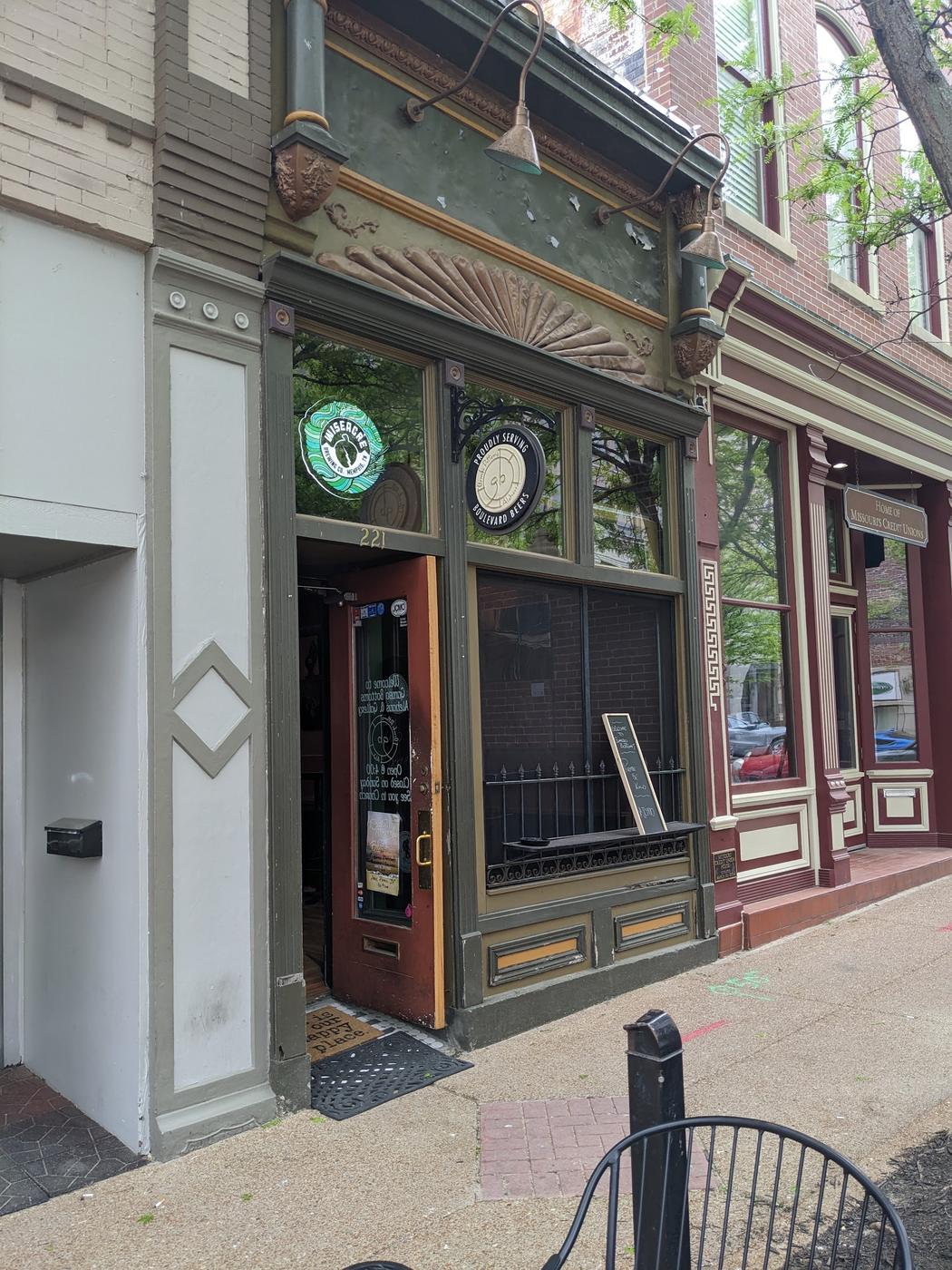Gumbo Bottoms Ale House by day: a green painted Victorian storefront at 221 Madison Street with a carved fan above the door